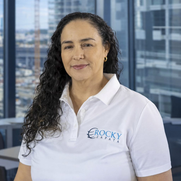Woman in Rocky Zapata Safety Consultants polo shirt, professional setting, showcasing expertise in occupational safety consulting.