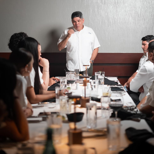 the-rocky-group-conference Team meeting at The Rocky Group with CEO Rocky Zapata addressing dedicated experts in a collaborative setting, focused on renewable energy and strategic investment initiatives.