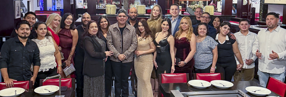 rocky_zapata_safety_staff_panoramic Group photo of Rocky Zapata Safety Consulting team members celebrating, showcasing diverse professionals in formal attire in a restaurant setting, emphasizing teamwork and community in safety consulting.